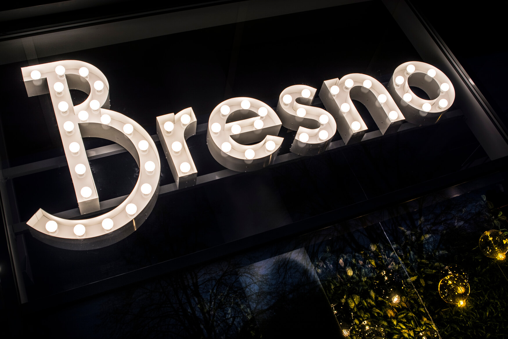 Bresno - letters with light bulbs behind glass